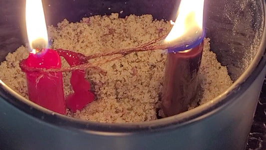 Two candles burning either side of a cord that will not sever